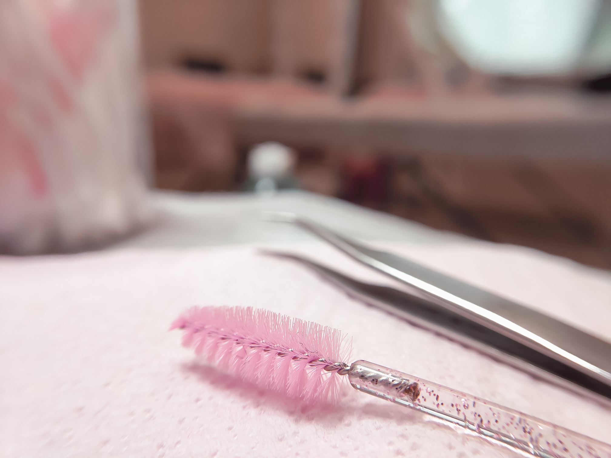 Close-up of Tweezers and Clean Mascara Wand